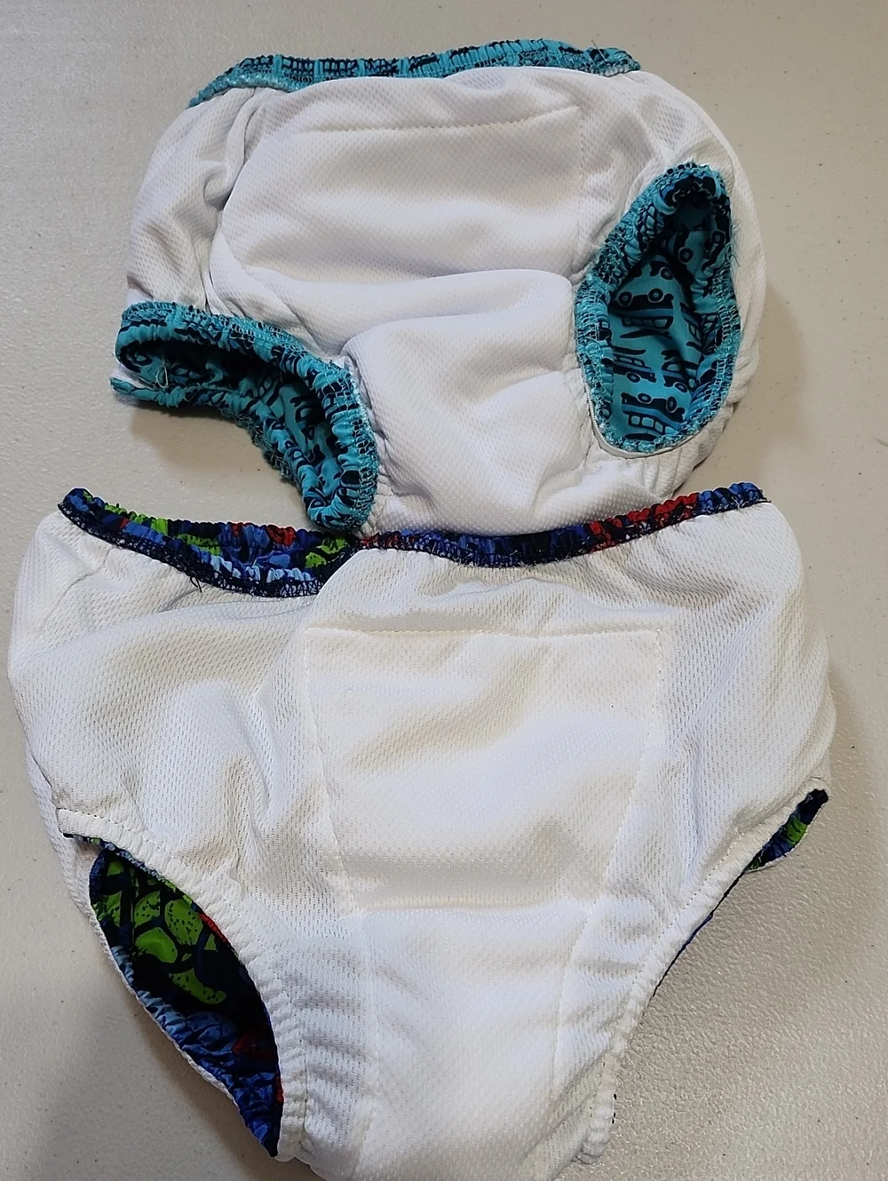 EUC 2 Pairs SzXL&3T Toddler Swim Diapers in Aqua, Navy & Bright Accent Prints.